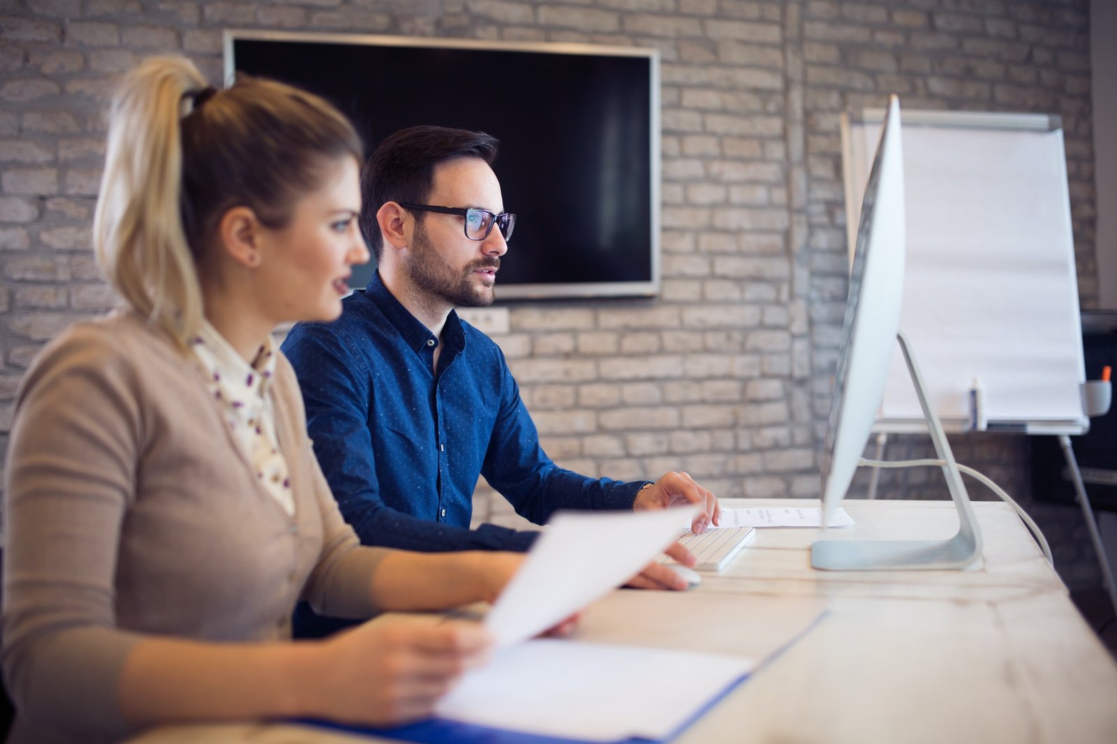 Coworking and corporate colleagues working in office