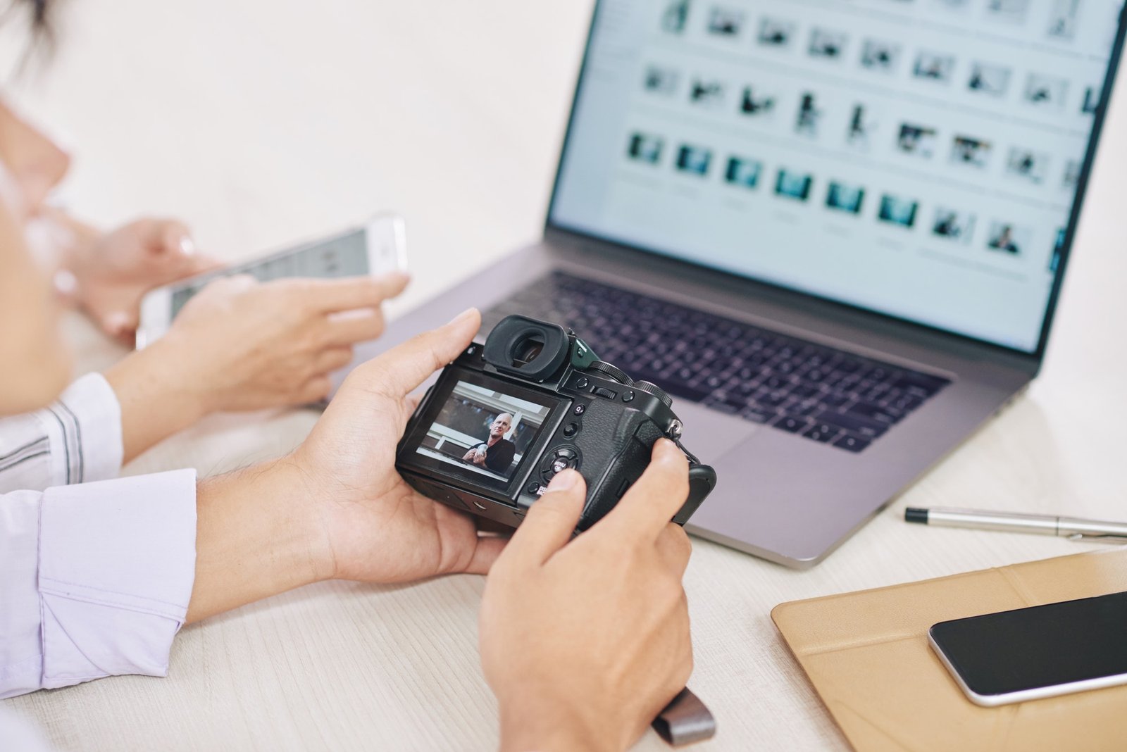 Crop photographers with laptop and camera